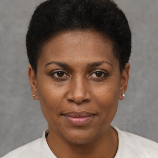 Joyful black young-adult female with short  black hair and brown eyes