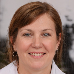 Joyful white adult female with medium  brown hair and brown eyes