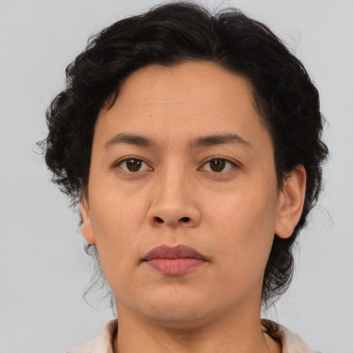 Neutral asian adult female with medium  brown hair and brown eyes