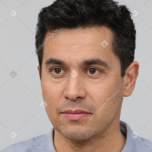 Joyful white young-adult male with short  black hair and brown eyes