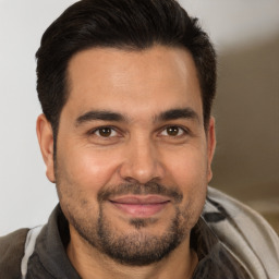 Joyful white adult male with short  brown hair and brown eyes