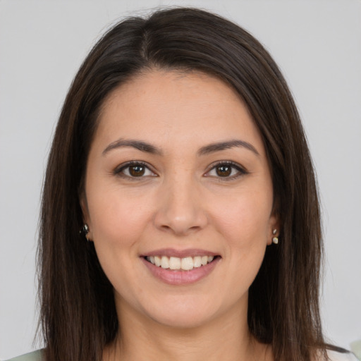 Joyful white young-adult female with long  brown hair and brown eyes
