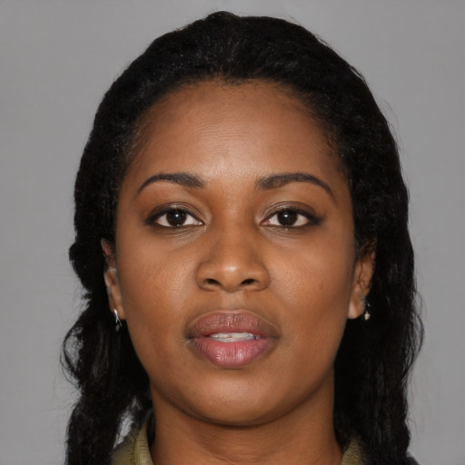 Joyful black young-adult female with long  black hair and brown eyes