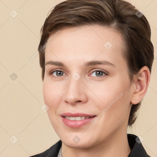 Joyful white young-adult female with short  brown hair and brown eyes