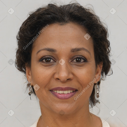 Joyful black adult female with medium  brown hair and brown eyes