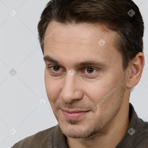 Joyful white adult male with short  brown hair and brown eyes