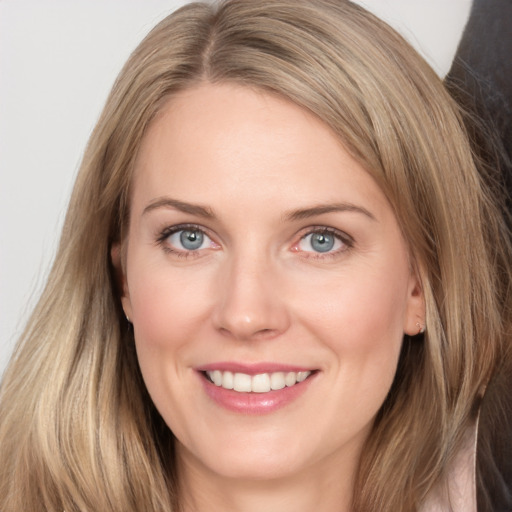 Joyful white young-adult female with long  brown hair and grey eyes