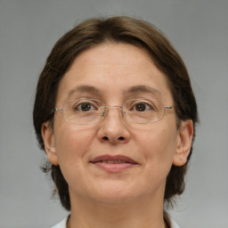 Joyful white adult female with medium  brown hair and grey eyes