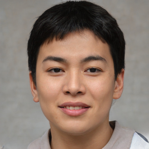 Joyful asian young-adult male with short  black hair and brown eyes