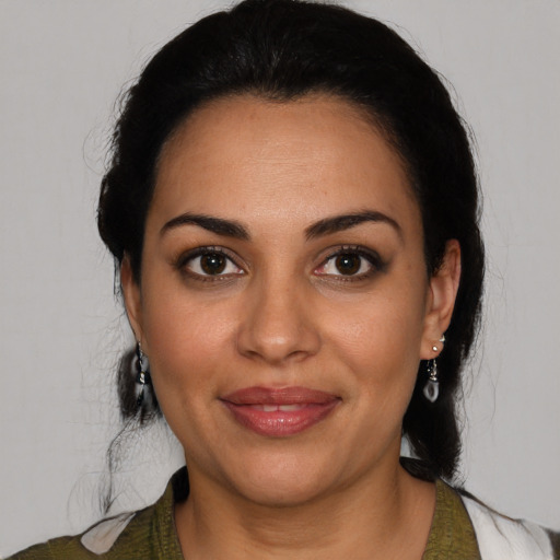 Joyful latino young-adult female with medium  black hair and brown eyes