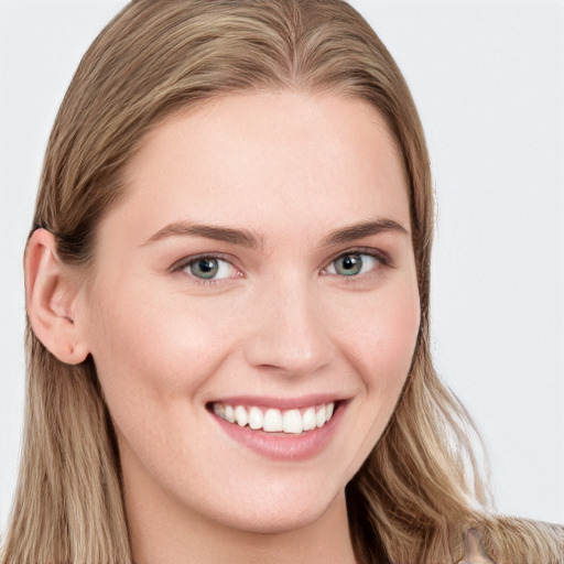 Joyful white young-adult female with long  brown hair and blue eyes