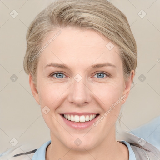 Joyful white adult female with medium  brown hair and blue eyes