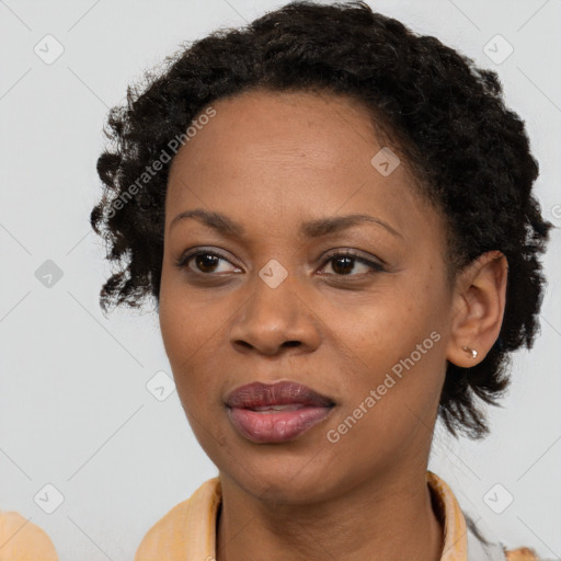 Joyful black adult female with short  brown hair and brown eyes