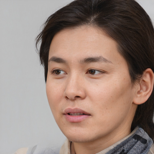 Joyful asian young-adult male with medium  brown hair and brown eyes