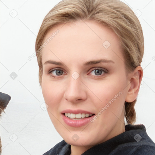 Joyful white young-adult female with medium  brown hair and blue eyes