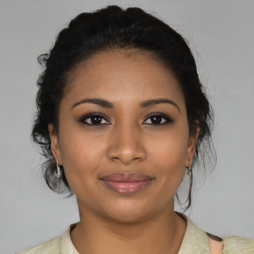 Joyful black young-adult female with medium  black hair and brown eyes