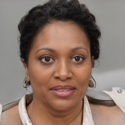 Joyful black adult female with short  brown hair and brown eyes