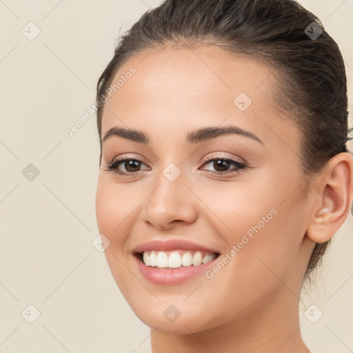 Joyful white young-adult female with long  brown hair and brown eyes