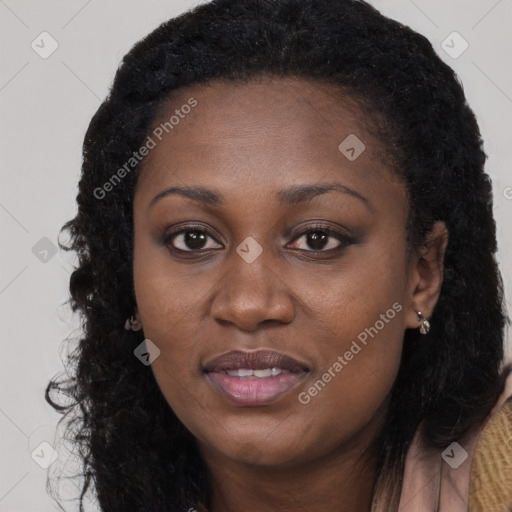 Joyful black young-adult female with long  brown hair and brown eyes