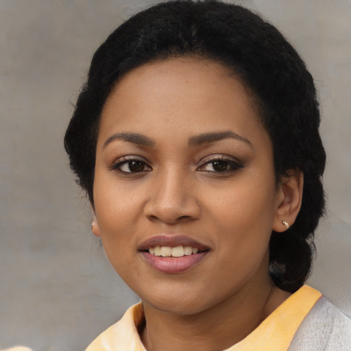 Joyful latino young-adult female with short  black hair and brown eyes