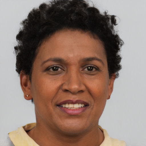Joyful latino adult female with short  brown hair and brown eyes