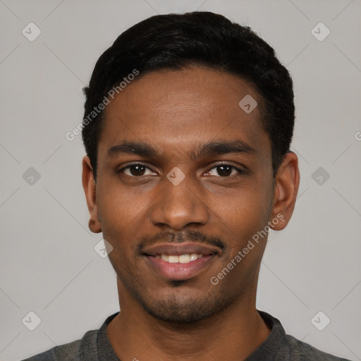 Joyful black young-adult male with short  black hair and brown eyes