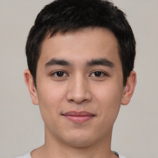 Joyful white young-adult male with short  black hair and brown eyes