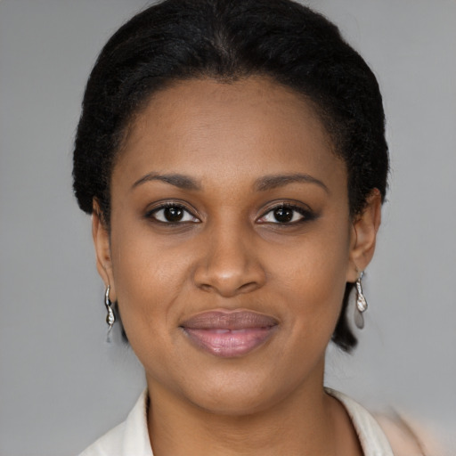 Joyful black young-adult female with medium  brown hair and brown eyes
