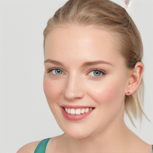 Joyful white young-adult female with medium  brown hair and blue eyes