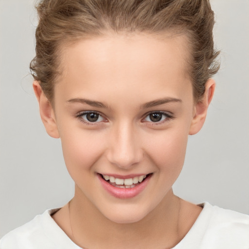 Joyful white child female with short  brown hair and brown eyes