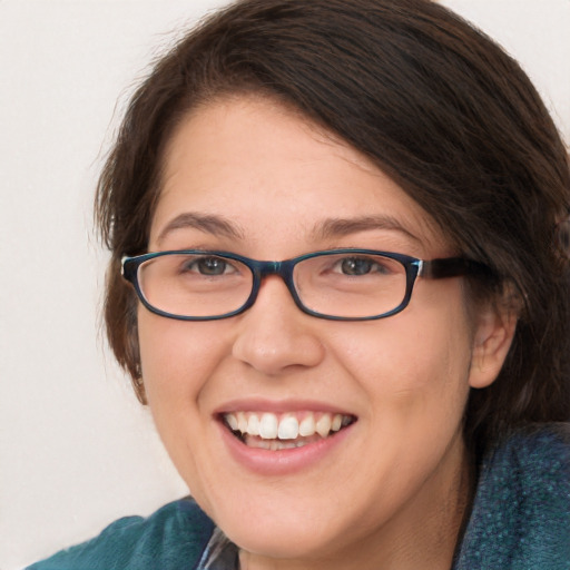 Joyful white young-adult female with medium  brown hair and blue eyes