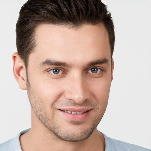 Joyful white young-adult male with short  brown hair and brown eyes