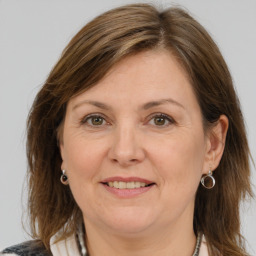 Joyful white adult female with medium  brown hair and grey eyes