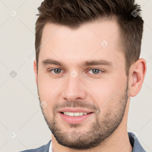 Joyful white young-adult male with short  brown hair and brown eyes