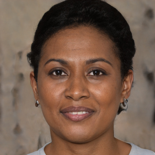 Joyful black young-adult female with short  brown hair and brown eyes