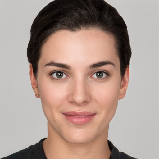 Joyful white young-adult female with short  brown hair and brown eyes