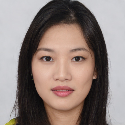 Joyful asian young-adult female with long  brown hair and brown eyes