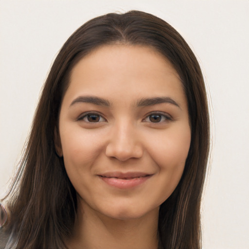 Joyful latino young-adult female with long  brown hair and brown eyes