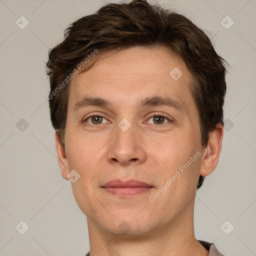 Joyful white adult male with short  brown hair and grey eyes