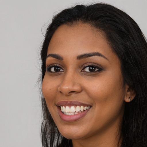 Joyful latino young-adult female with long  black hair and brown eyes