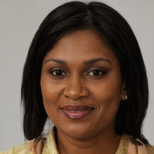Joyful black young-adult female with medium  brown hair and brown eyes