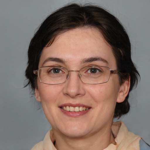 Joyful white adult female with medium  brown hair and blue eyes