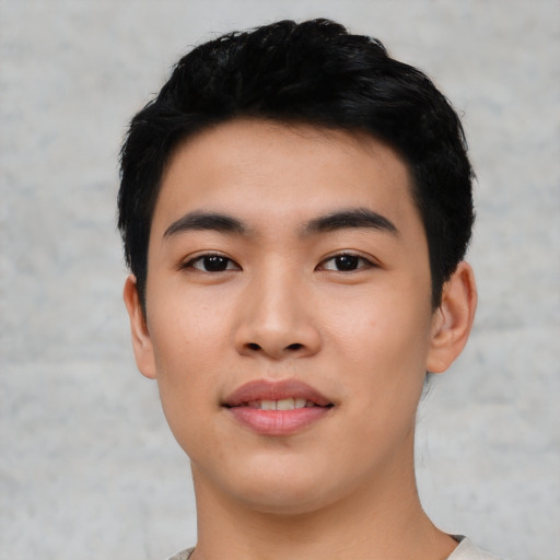 Joyful asian young-adult male with short  black hair and brown eyes