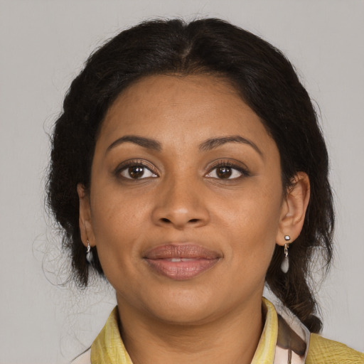 Joyful black adult female with medium  brown hair and brown eyes