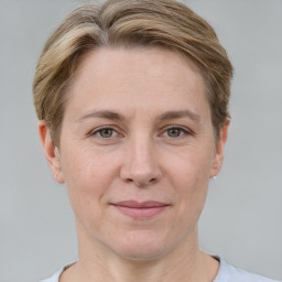 Joyful white adult female with short  brown hair and grey eyes