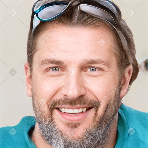 Joyful white adult male with short  brown hair and blue eyes