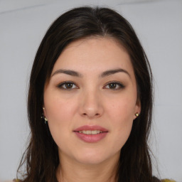 Joyful white young-adult female with long  brown hair and brown eyes