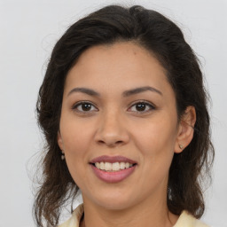 Joyful latino young-adult female with medium  brown hair and brown eyes