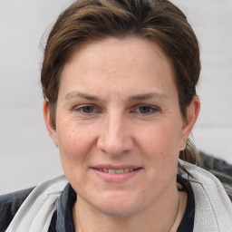 Joyful white adult female with short  brown hair and grey eyes