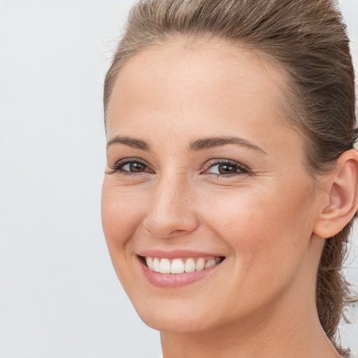 Joyful white young-adult female with long  brown hair and brown eyes